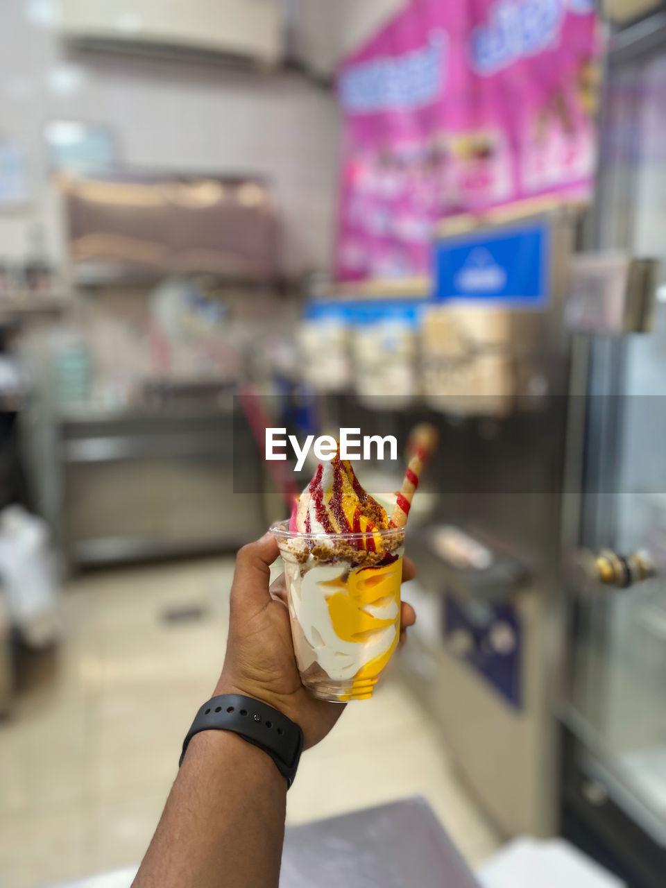 cropped hand of person holding ice cream cone