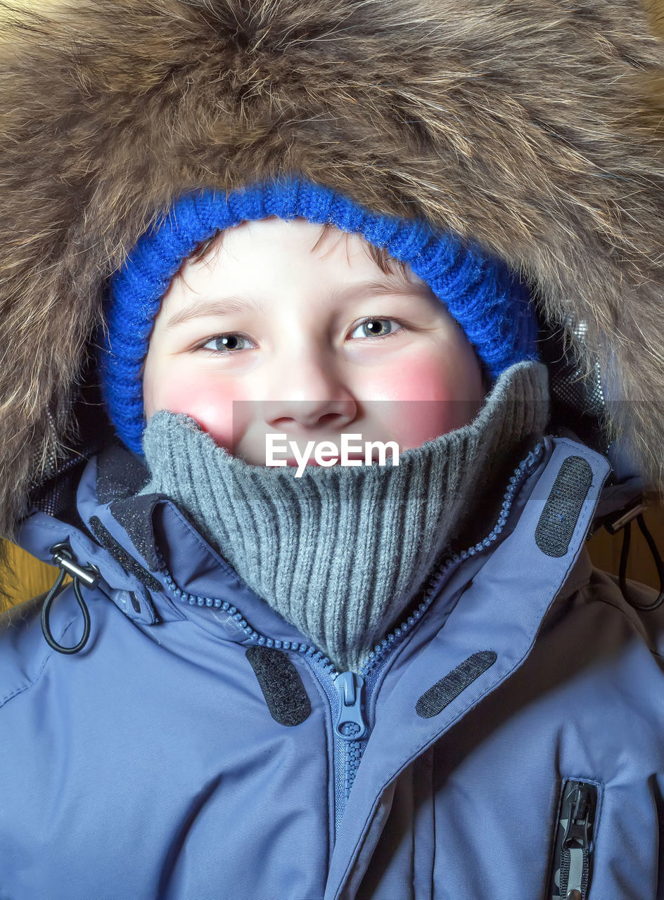 Portrait of a ten-year-old boy dressed in casual warm winter clothes. frosty weather