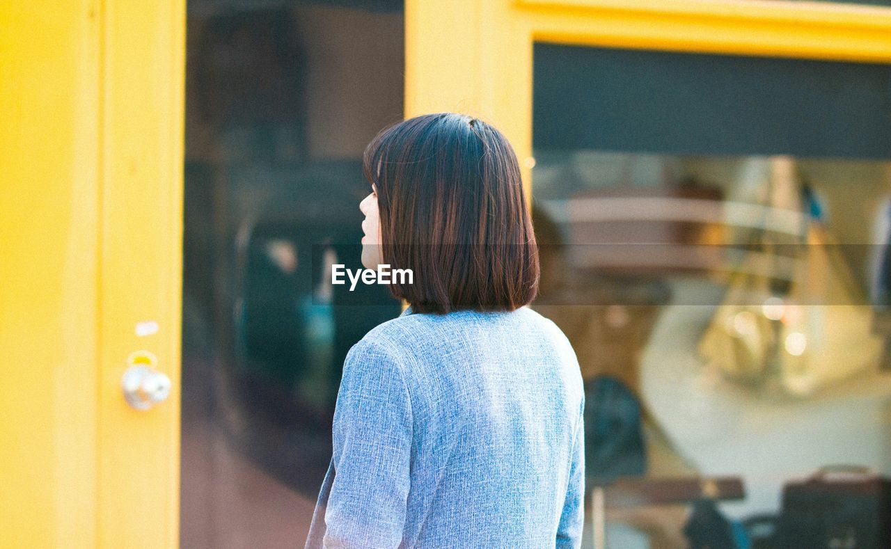 Woman looking at store window