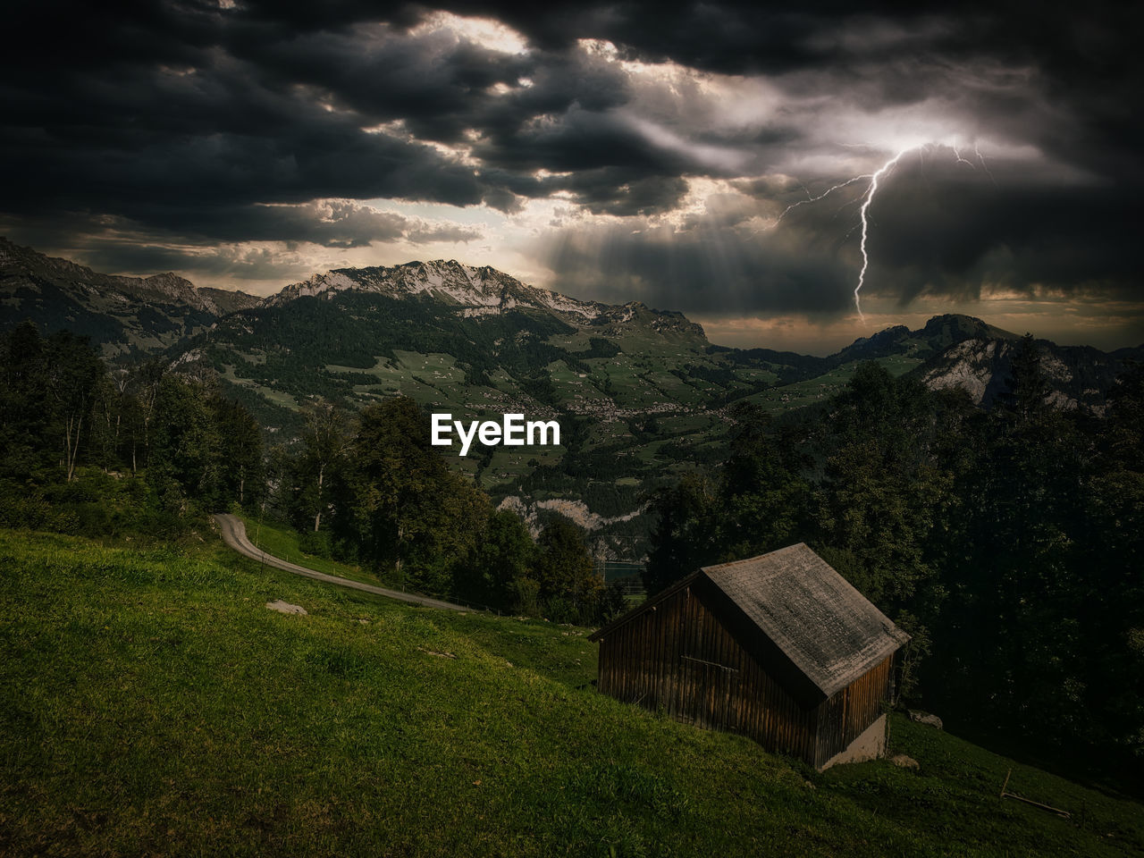 Scenic view of grassy field against cloudy sky