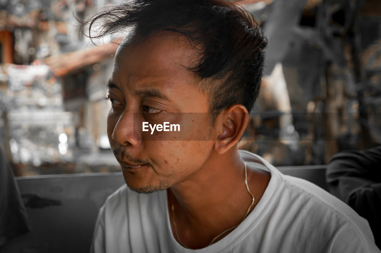PORTRAIT OF MAN LOOKING AWAY
