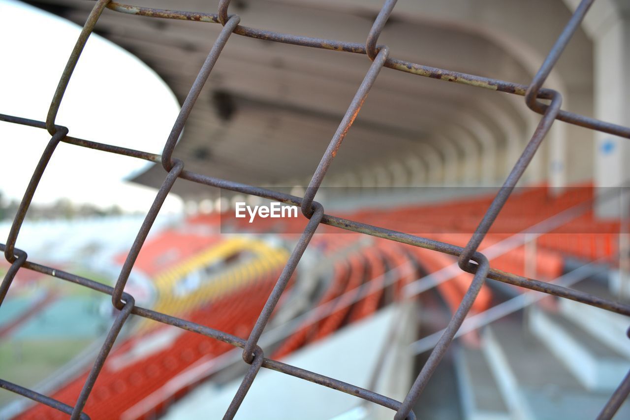 CLOSE-UP OF CHAINLINK FENCE AGAINST SKY