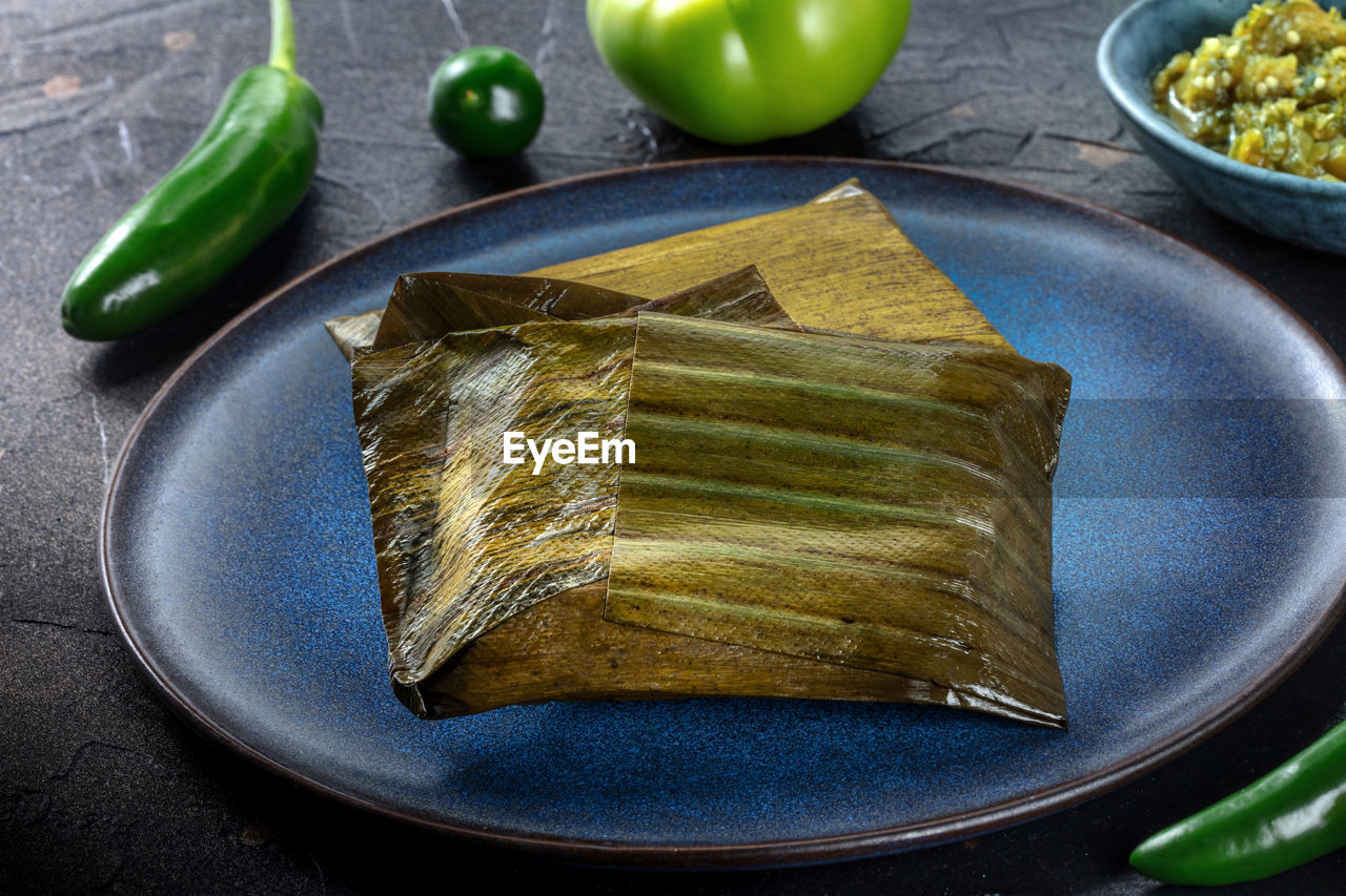 Tamales oaxaquenos, traditional dish of the cuisine of mexico, wrapped in green leaves