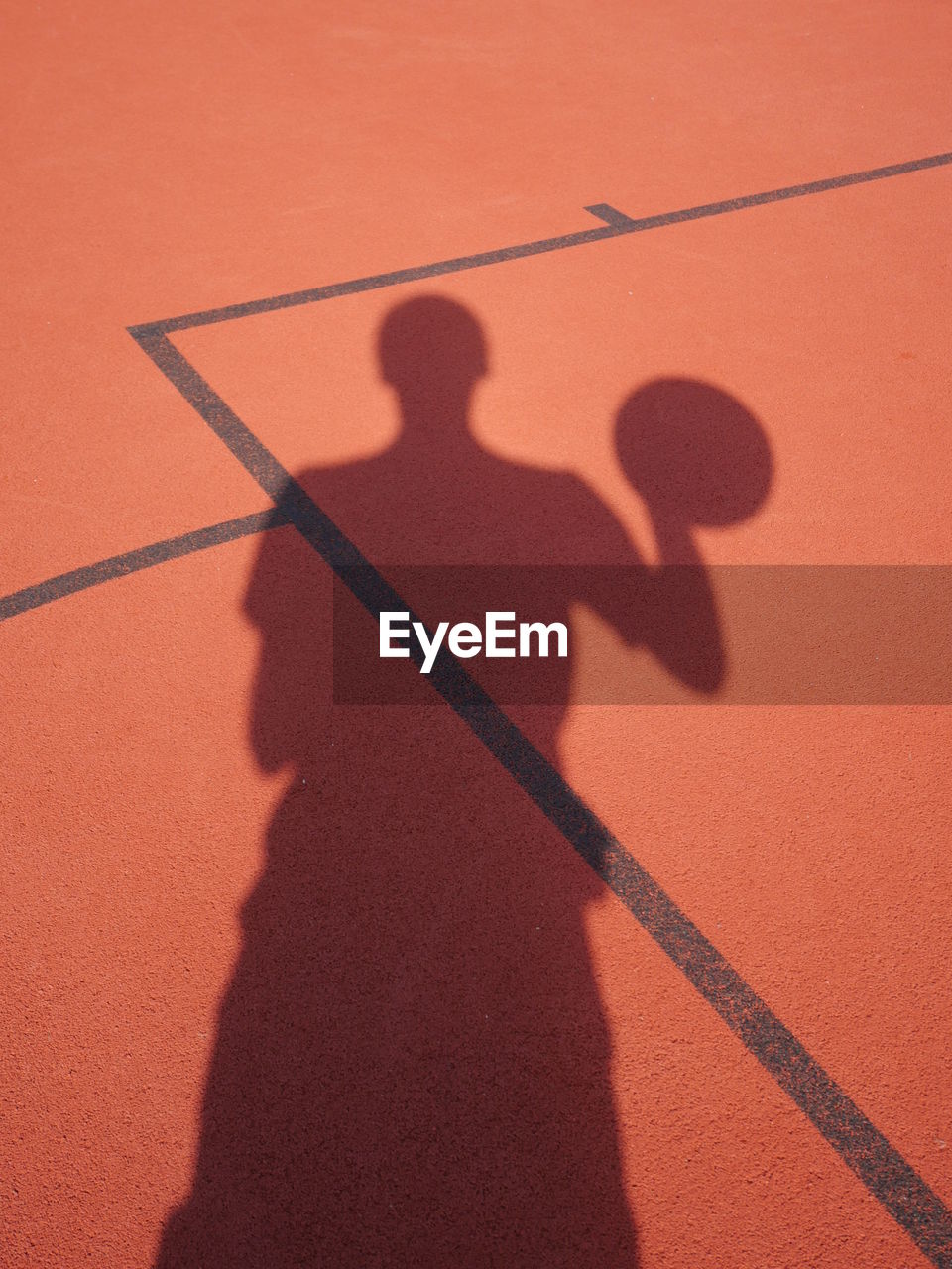 Shadow of player on basket ball court