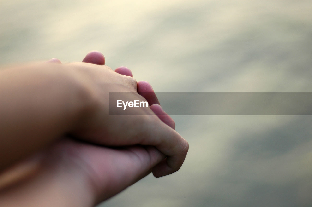Cropped Image Of Two People Holding Hands Id 94413965