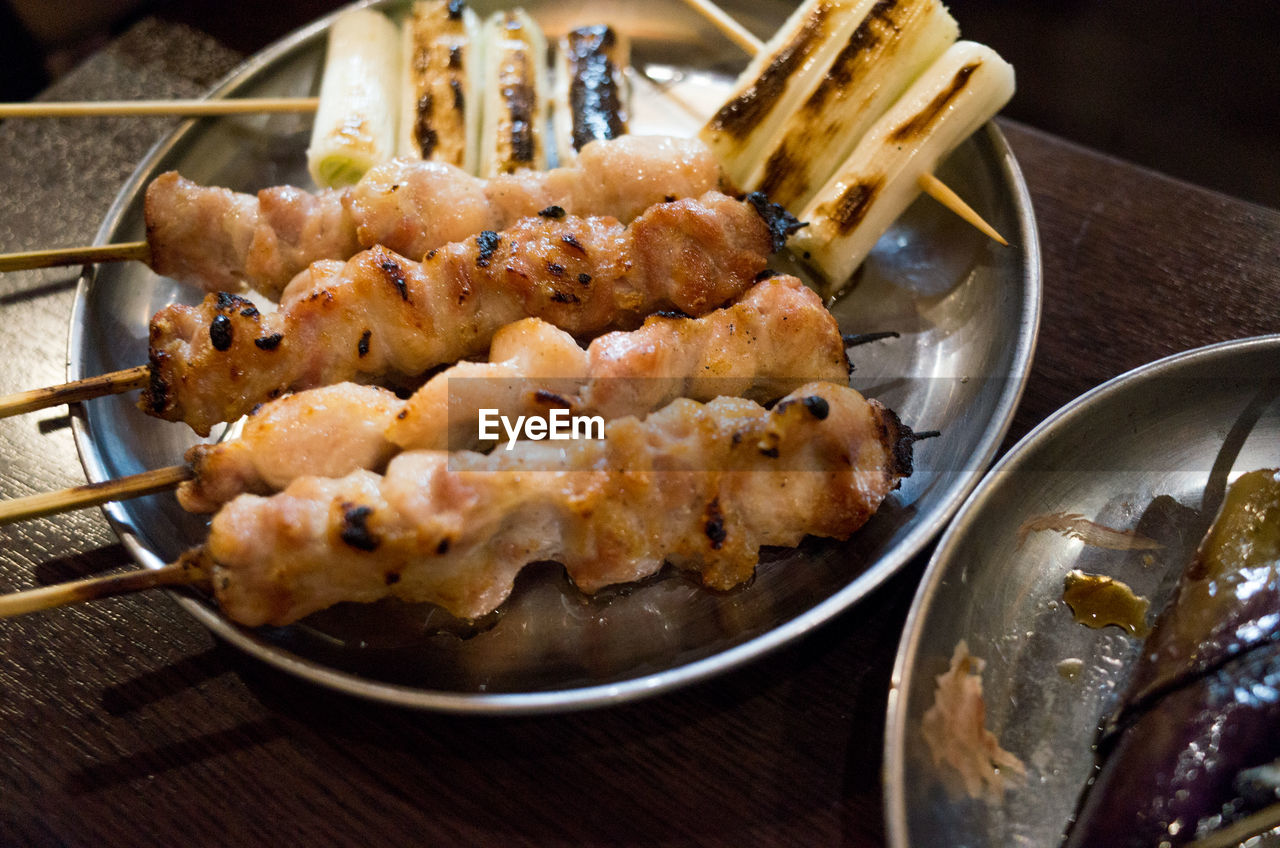 Close-up of chiken and long onion barbecue - japanese food yakitori and kushiyaki in izakaya