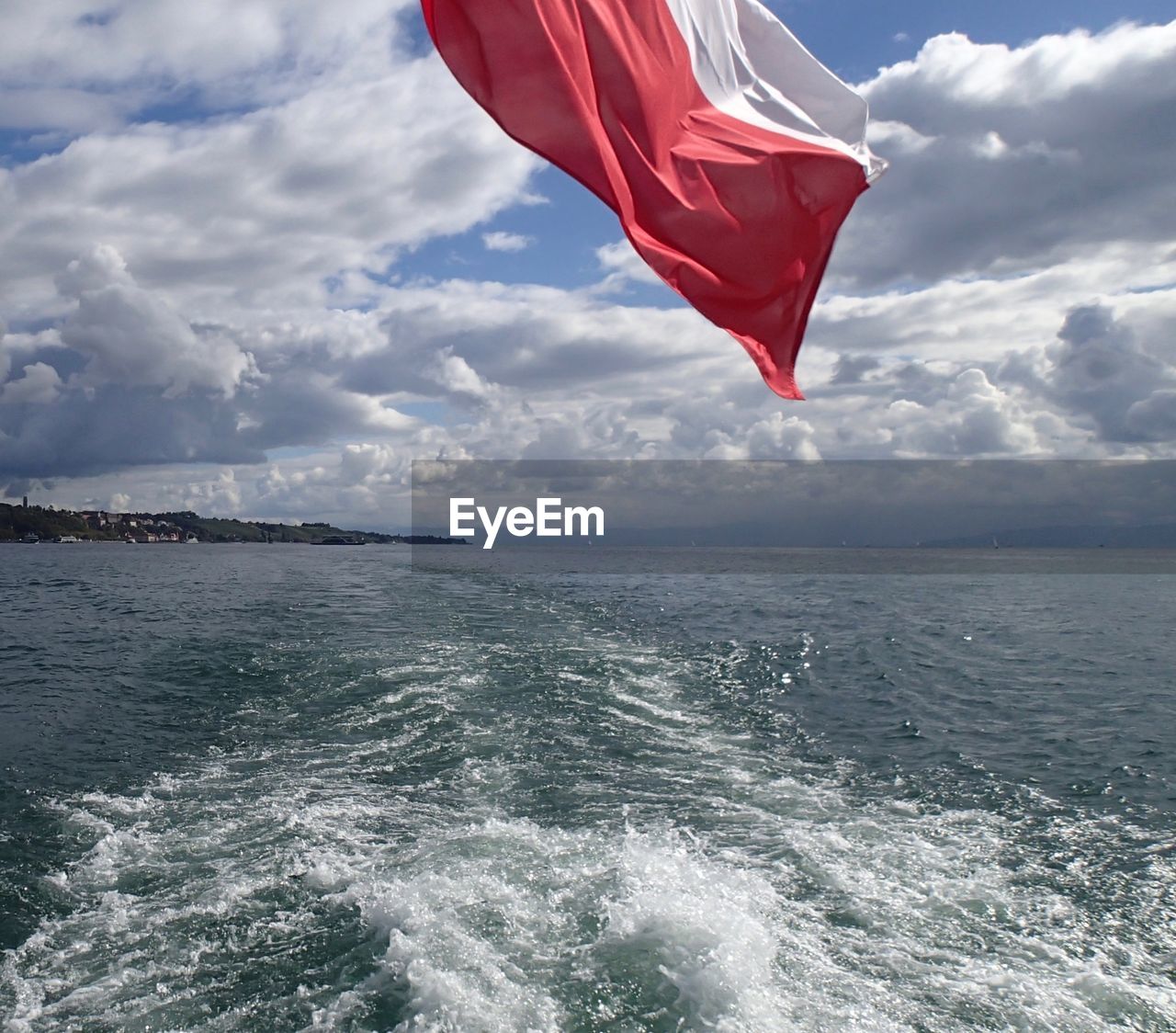 FLAG IN SEA AGAINST SKY
