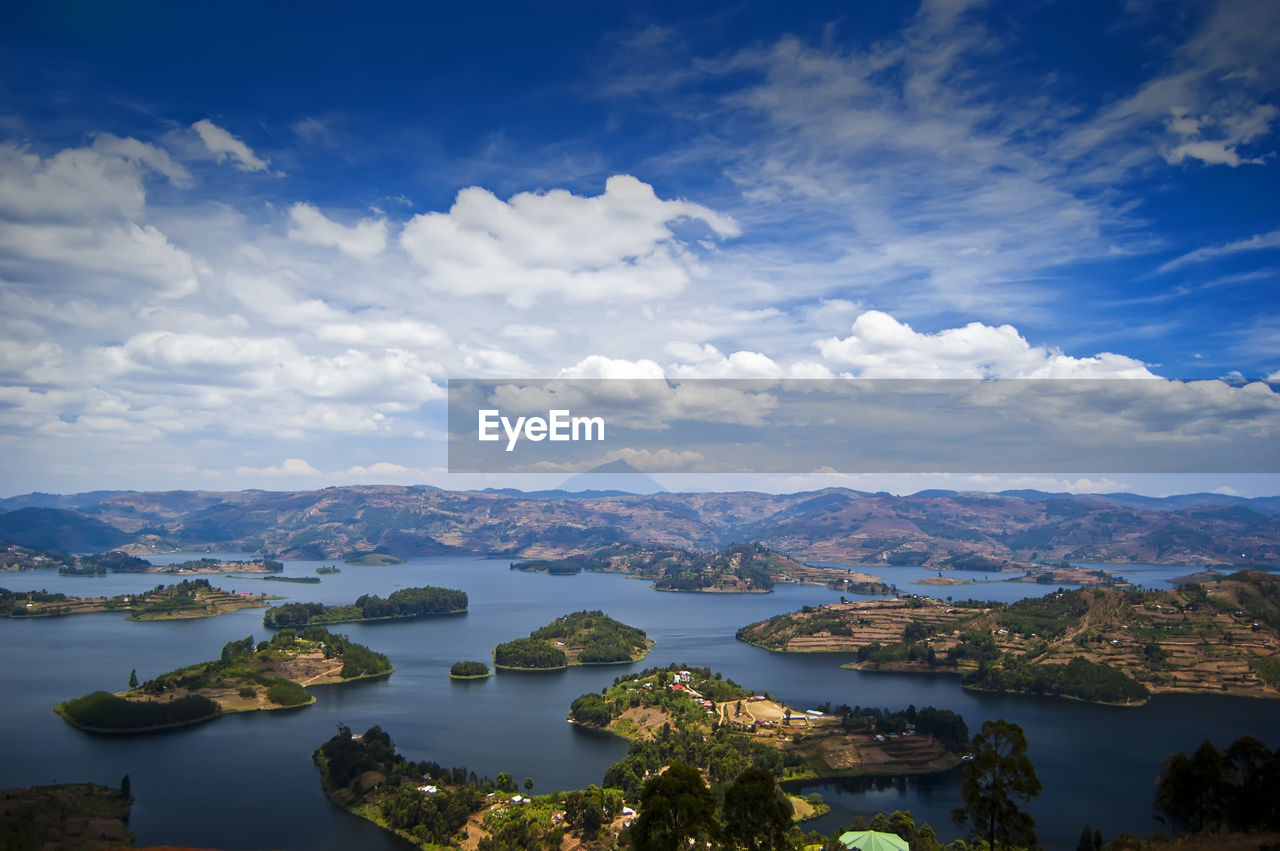 Scenic view of sea and mountains against sky