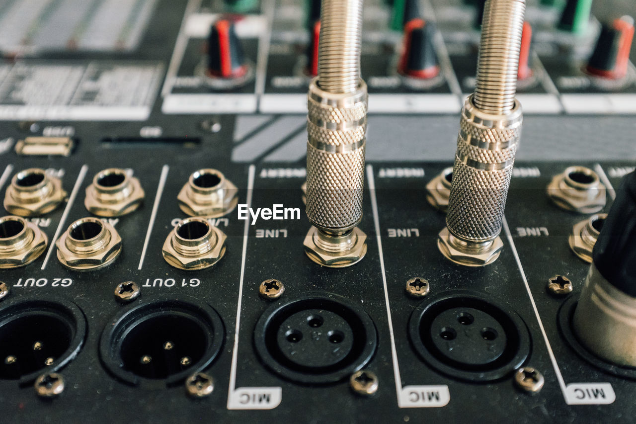 Close-up of jacks connected to sound mixer in recording studio