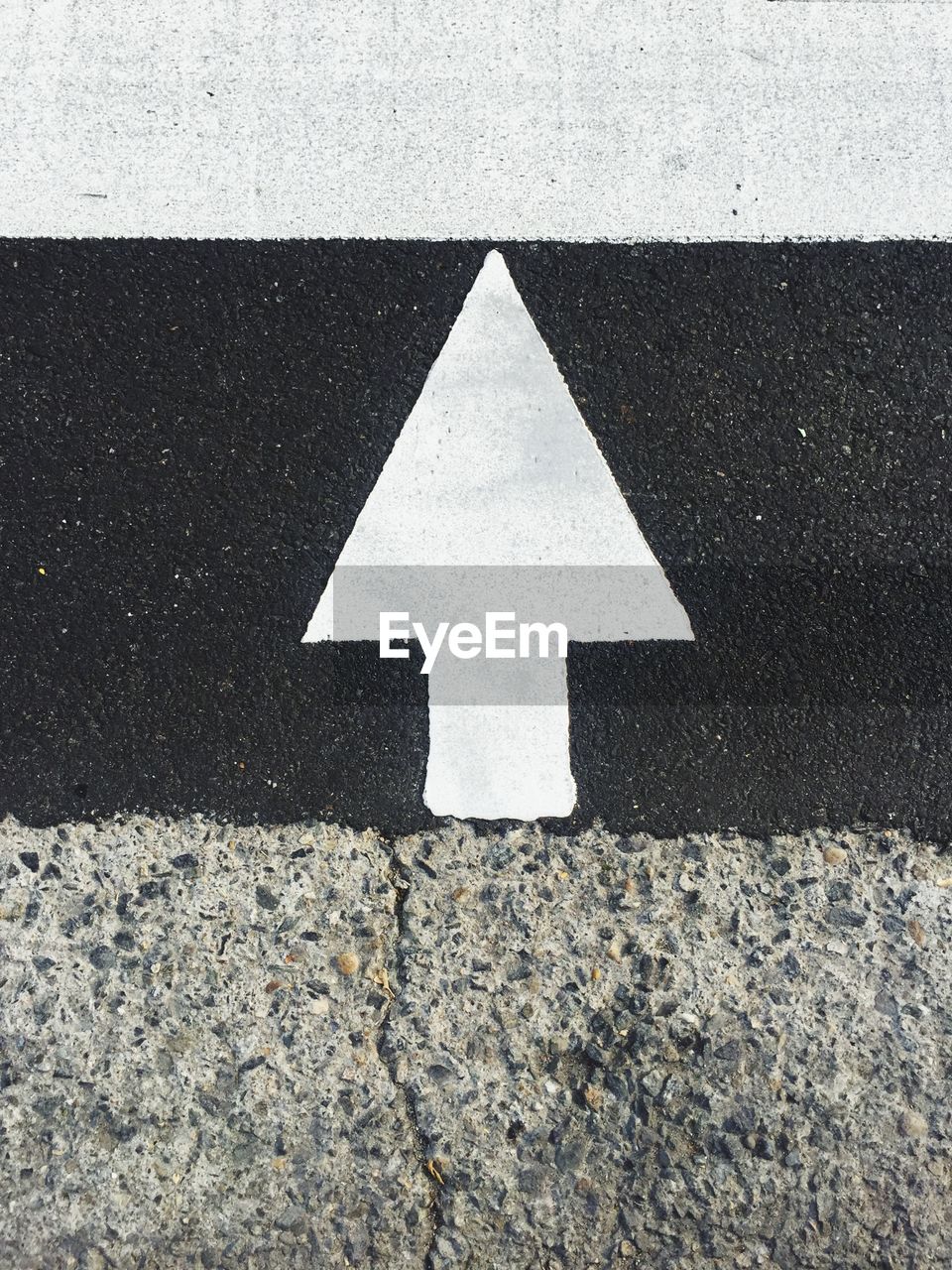 Close-up of arrow symbol on road