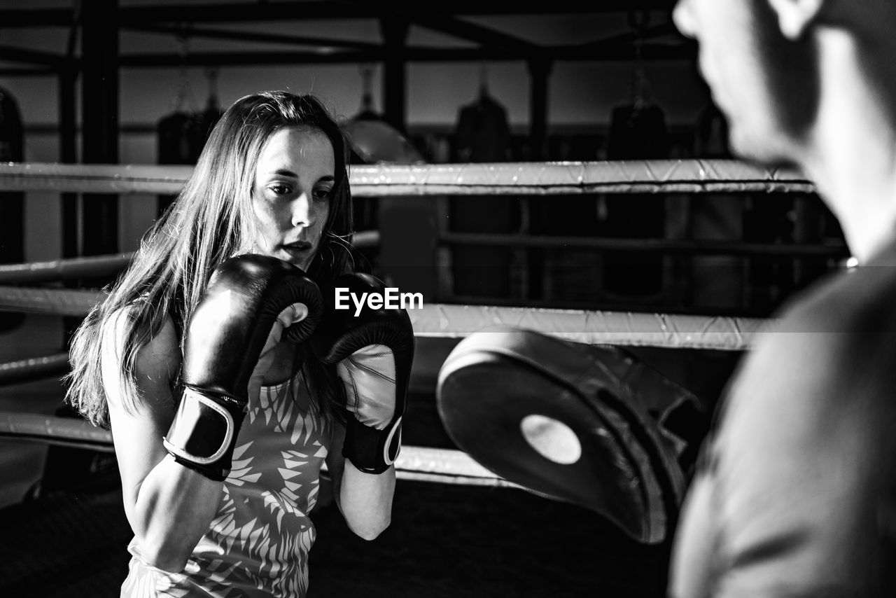 Woman on boxing training with personal trainer