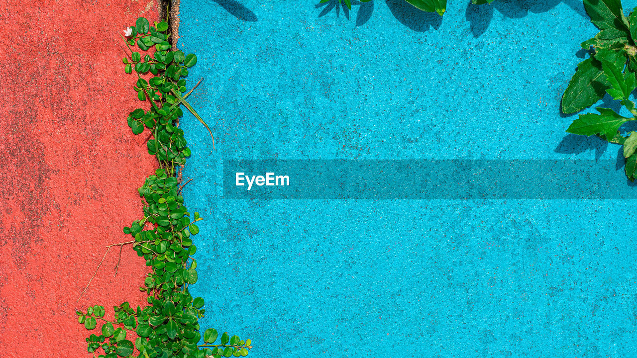 HIGH ANGLE VIEW OF SWIMMING POOL AGAINST BLUE SKY