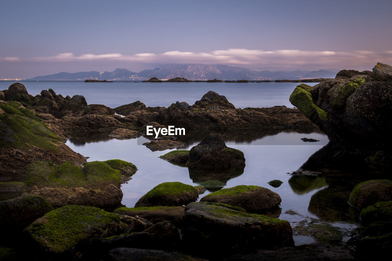 Rocks on sea against sky