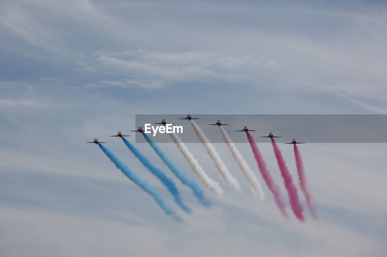 Low angle view of airshow in sky