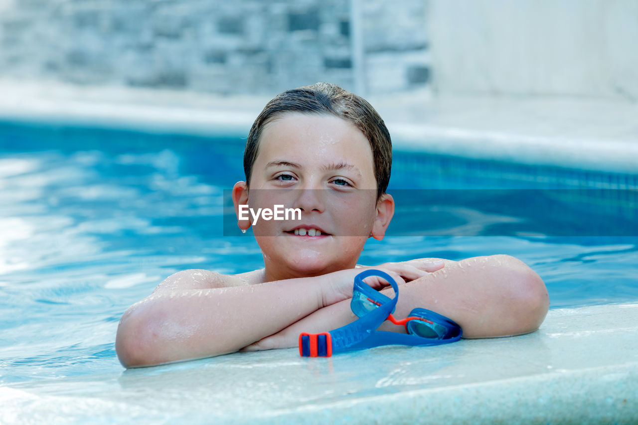 Portrait of boy smiling in swimming pool
