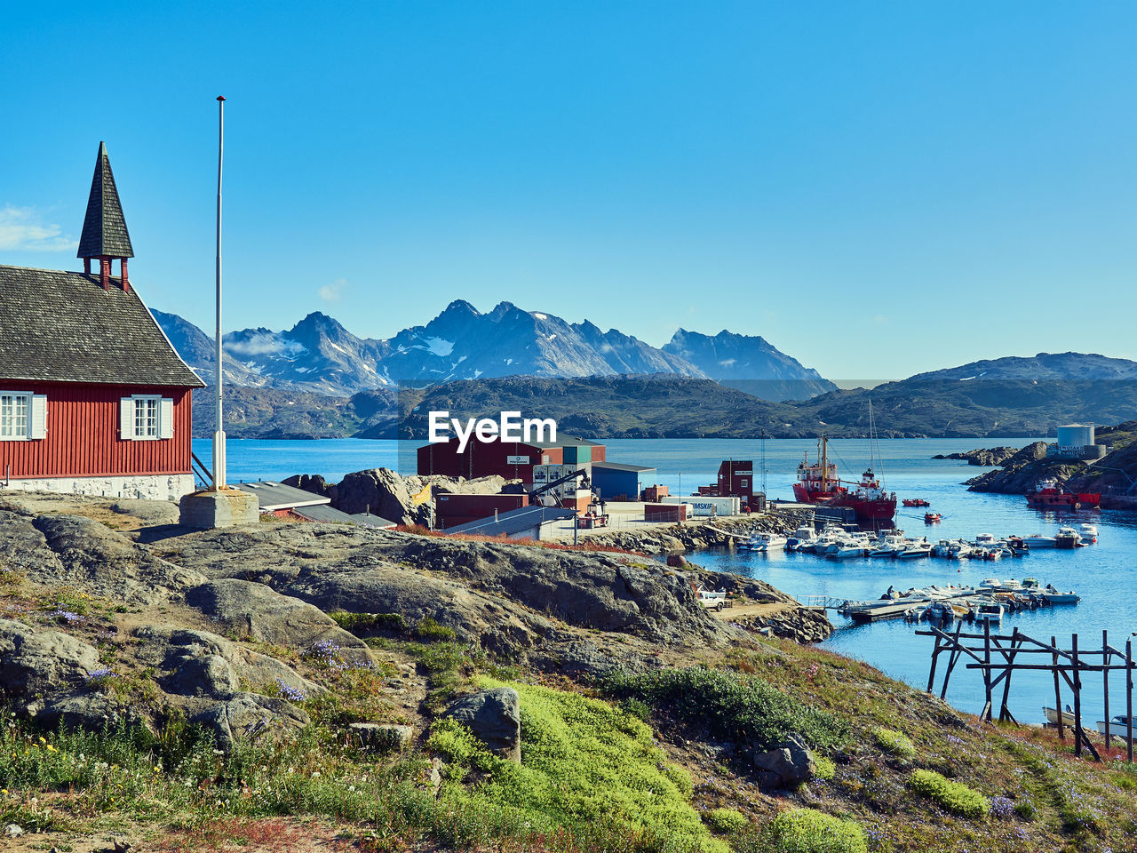 water, sky, mountain, architecture, coast, sea, nature, building exterior, built structure, building, vacation, scenics - nature, land, travel destinations, house, beauty in nature, landscape, clear sky, bay, mountain range, blue, beach, no people, travel, nautical vessel, day, environment, tranquility, transportation, outdoors, tourism, tranquil scene, shore, town, village, sunny, coastline, ocean, trip, idyllic, holiday, hut, residential district, body of water, sunlight, non-urban scene, harbor
