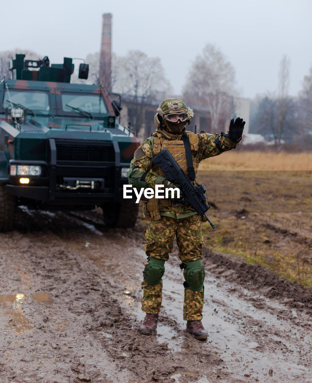 Soldier stops the car with a machine gun in his hands