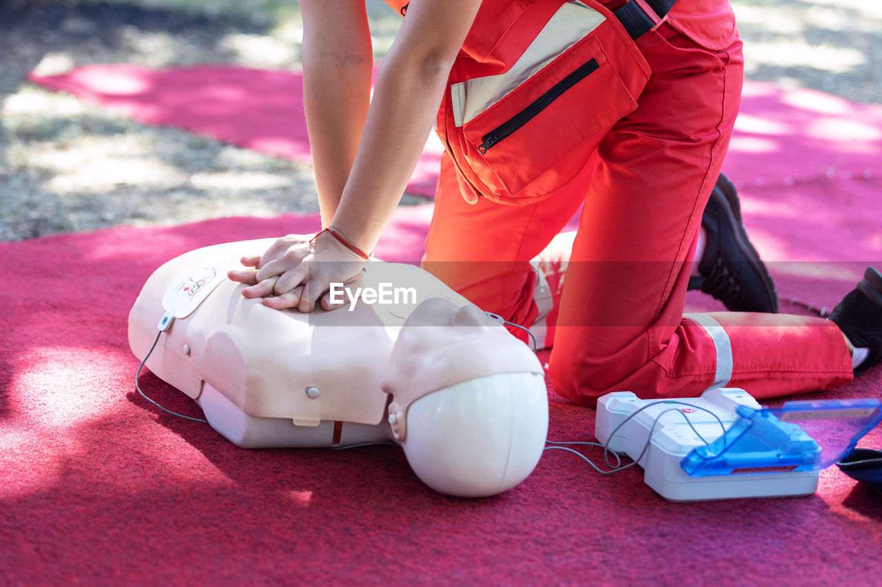 Hands of a paramedic doing chest compression during defibrillator cpr training
