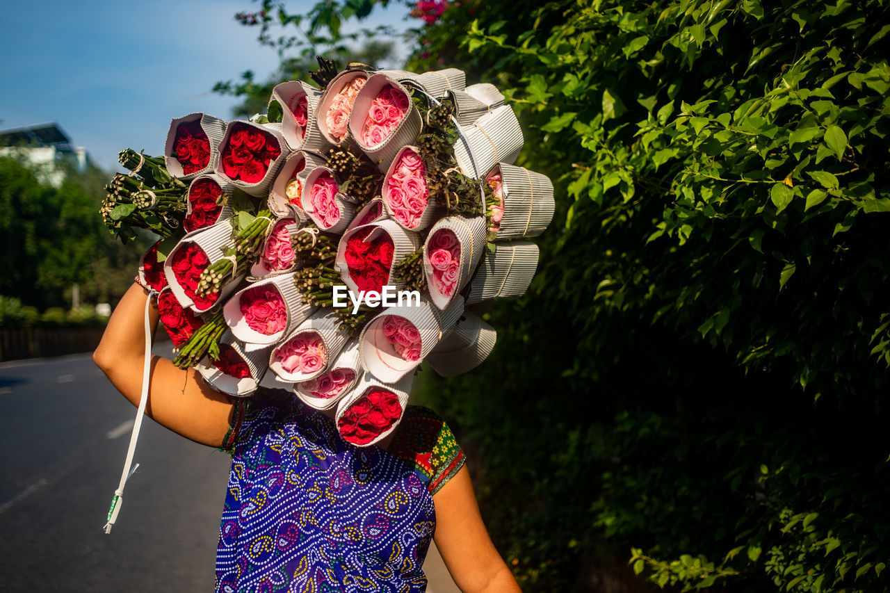 Woman carrying bouquet of roses