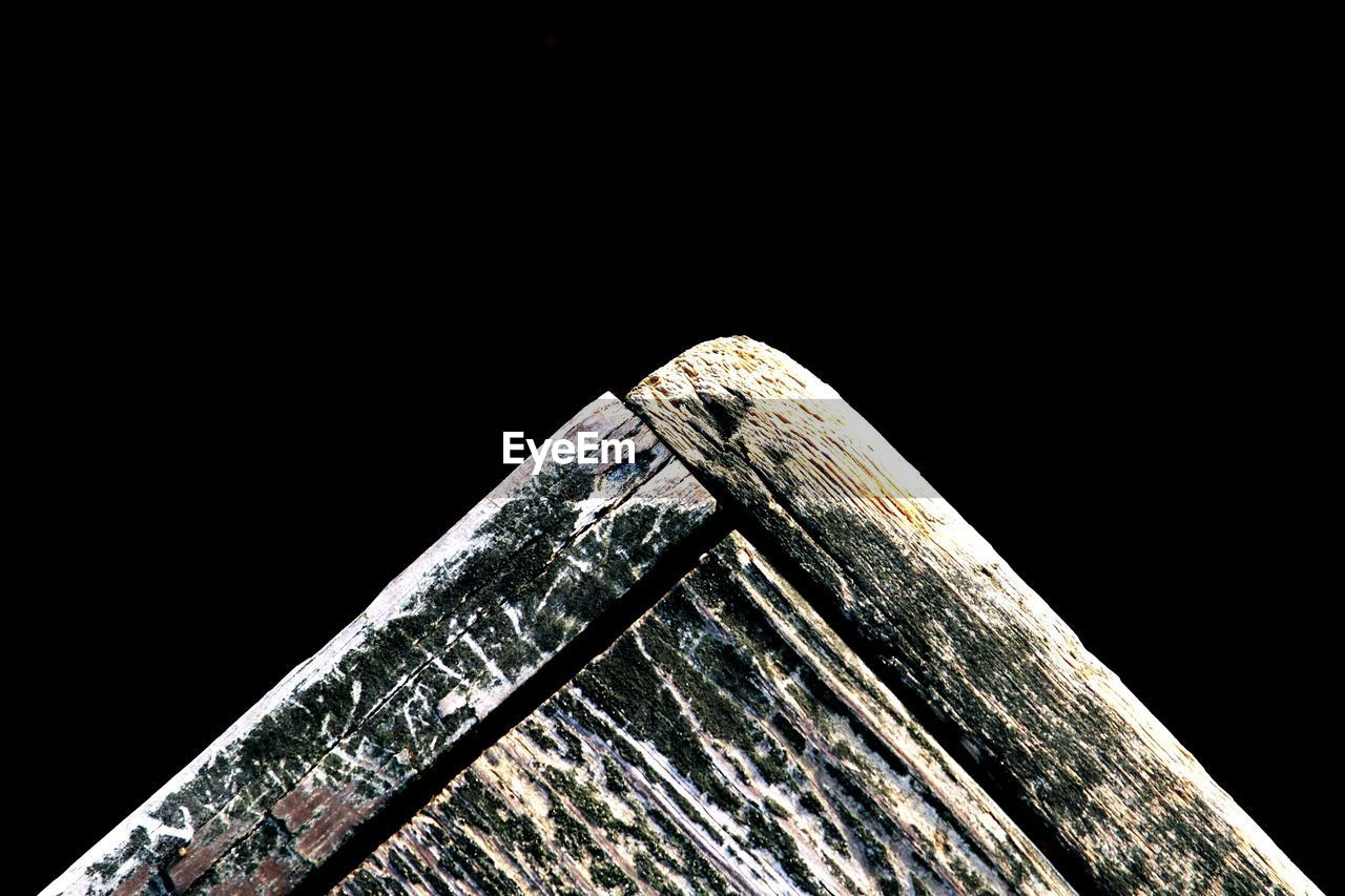 Detail shot of cropped wood over black background