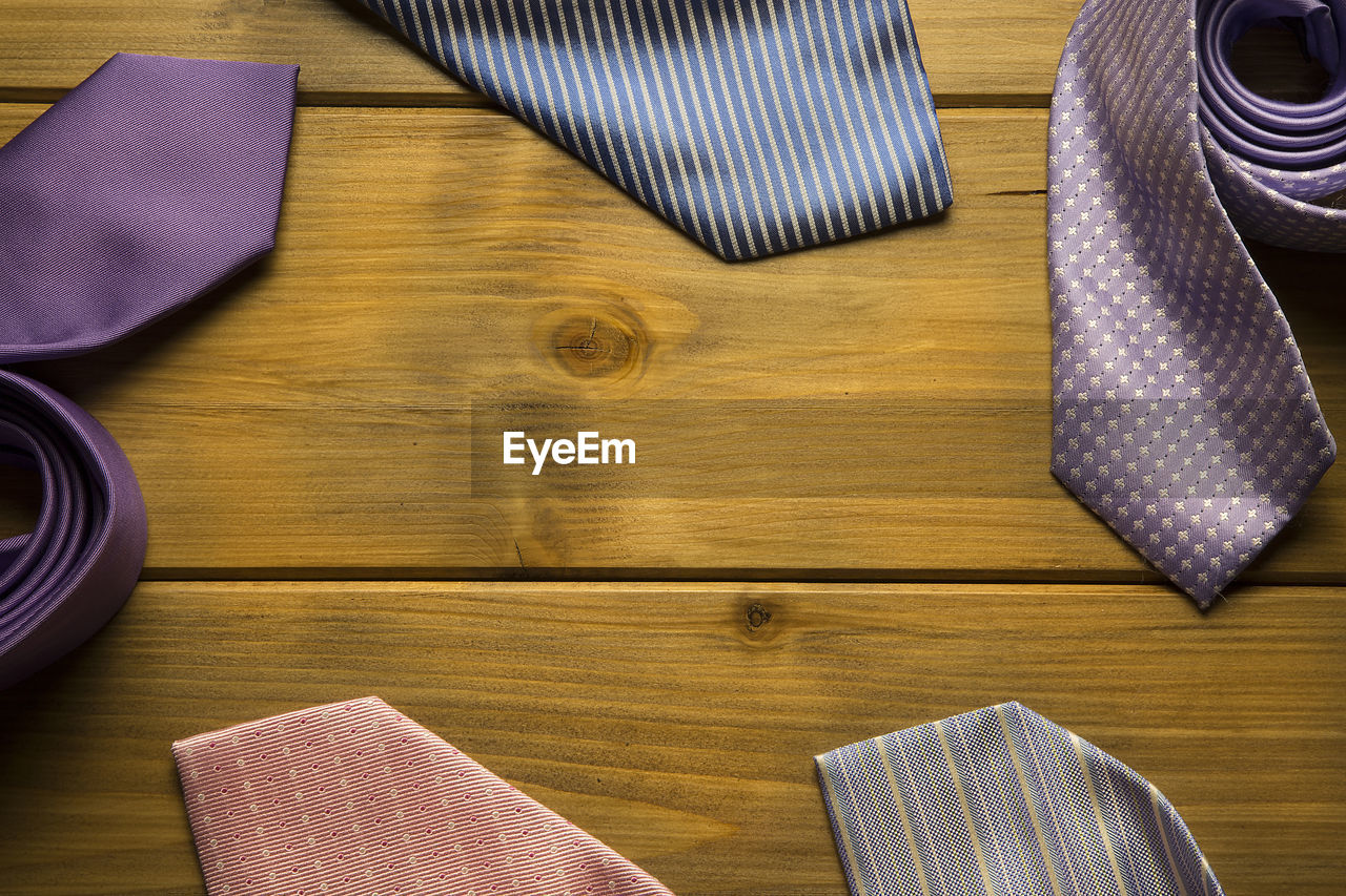 High angle view of colorful neckties on wooden table