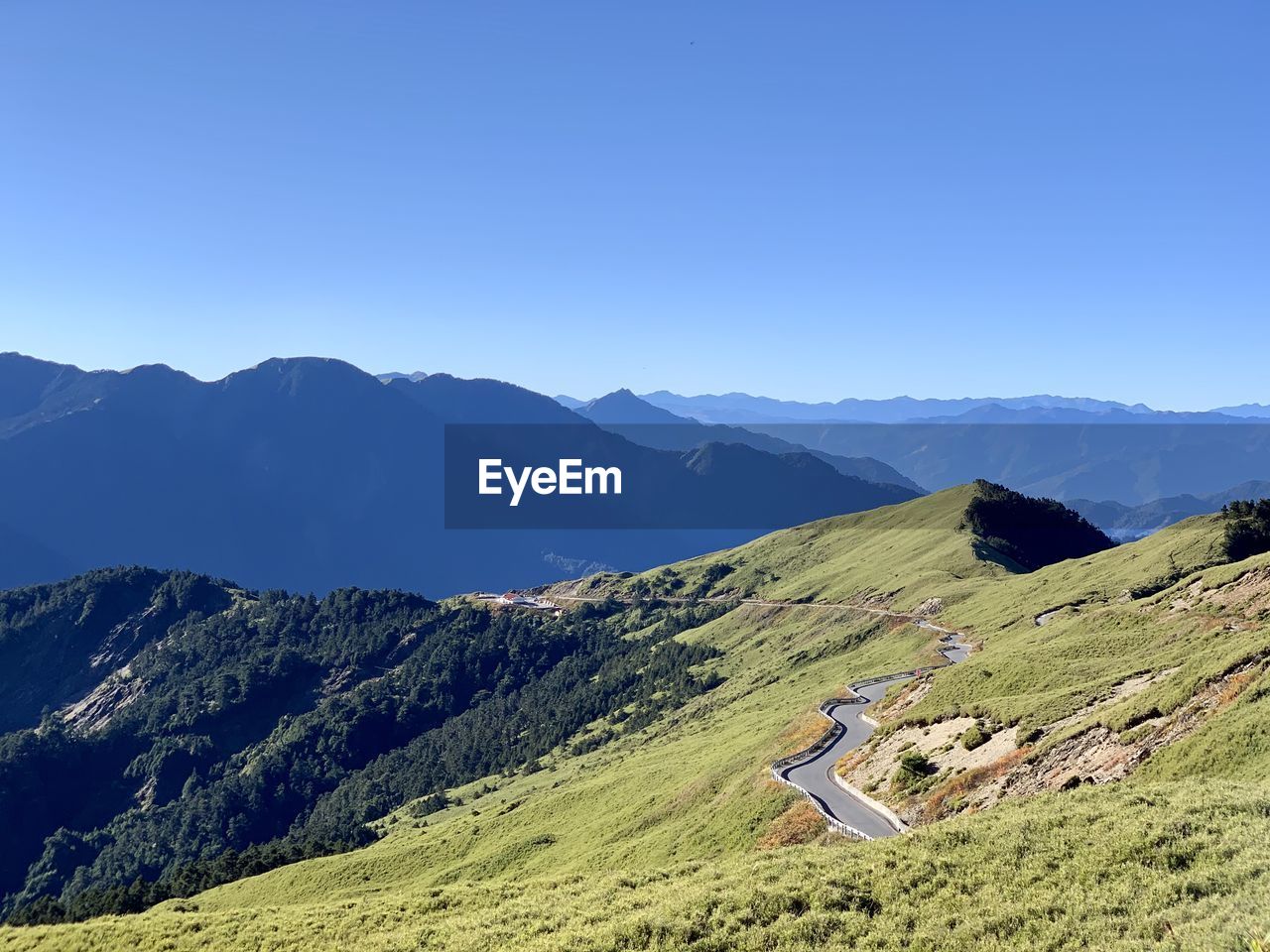 Scenic view of mountains against clear blue sky