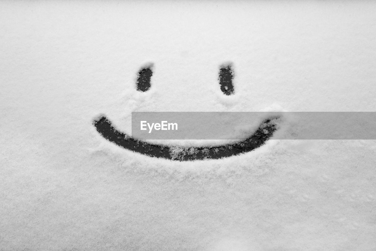 Smiley face drawn into snow
