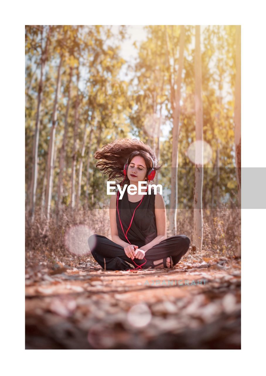 Woman With Tousled Hair Listening To Music While On Eyeem