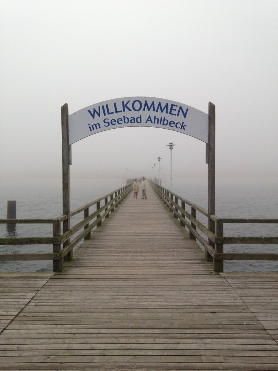 Welcome sign on ahlbeck pier during foggy weather