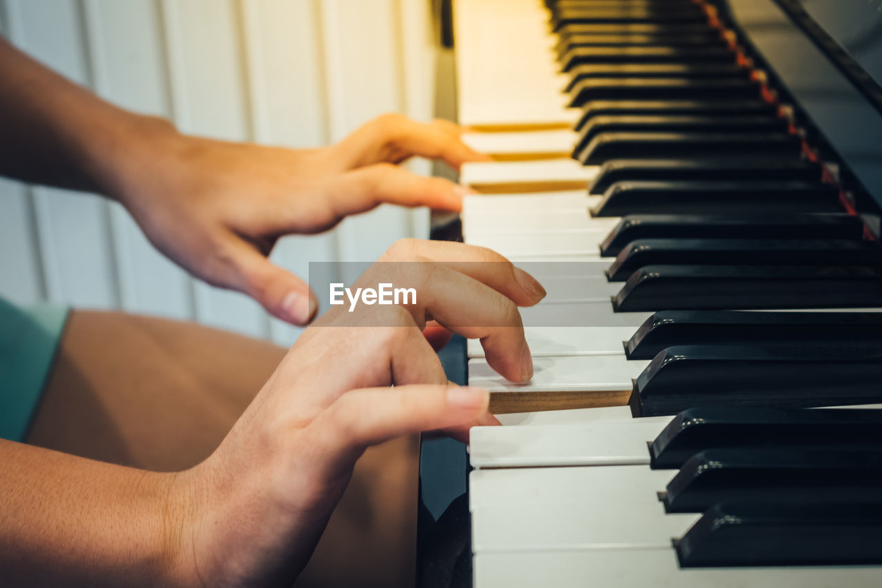 Cropped image of man playing piano