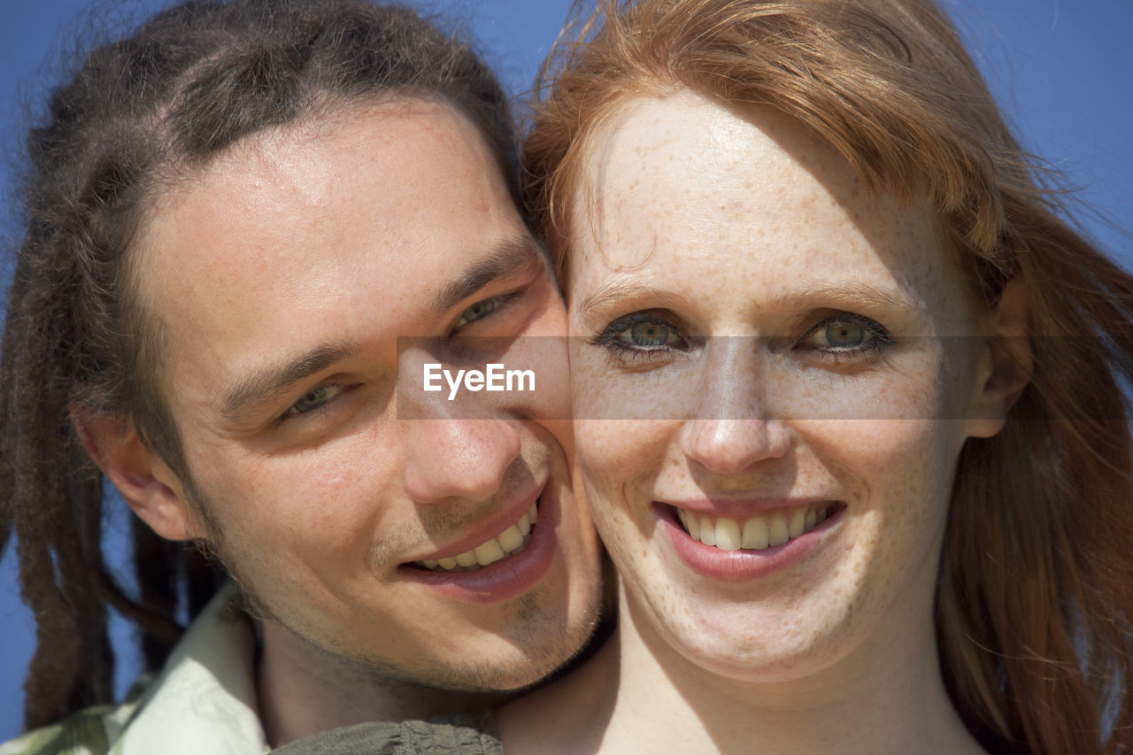 Close-up portrait of smiling young couple