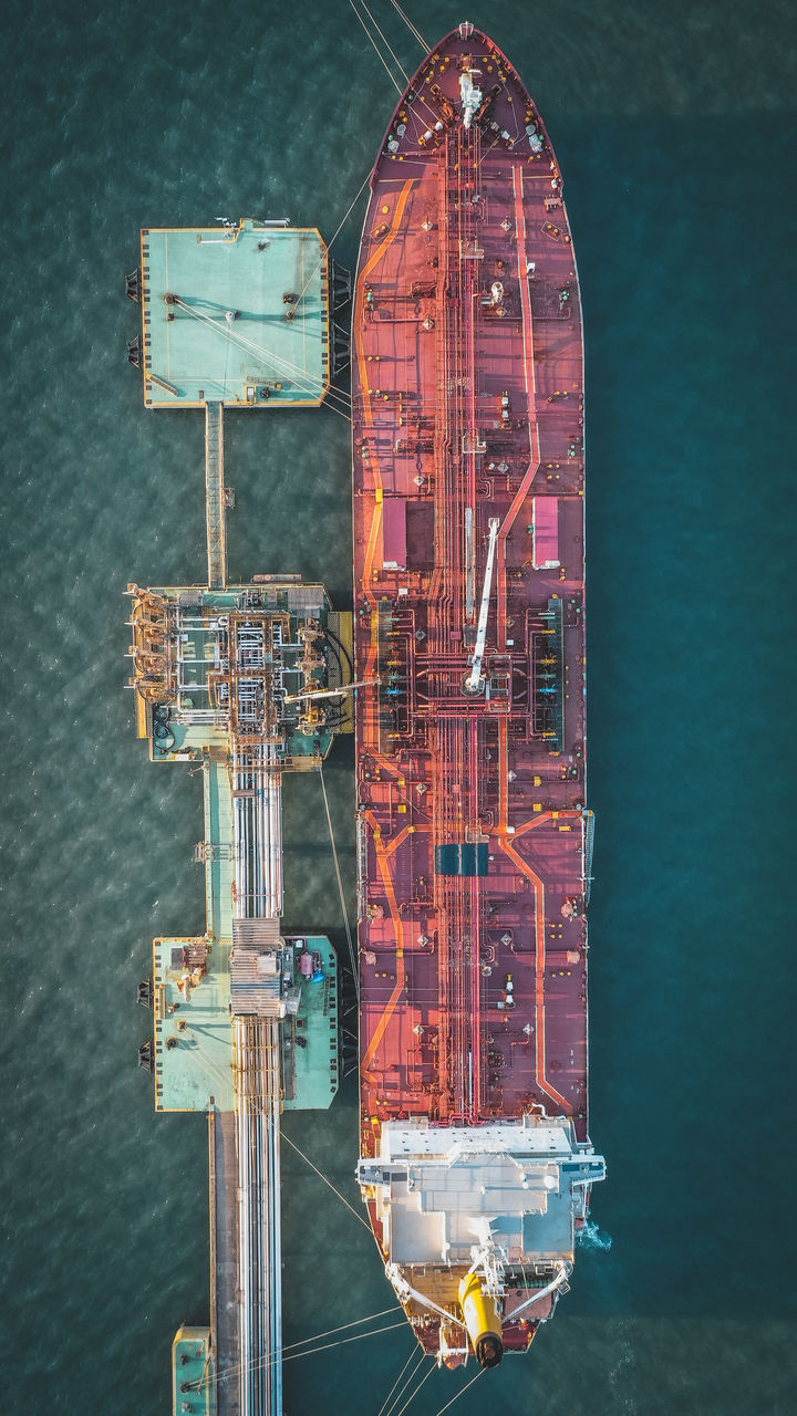 Aerial view of cargo ship moored by offshore platform 