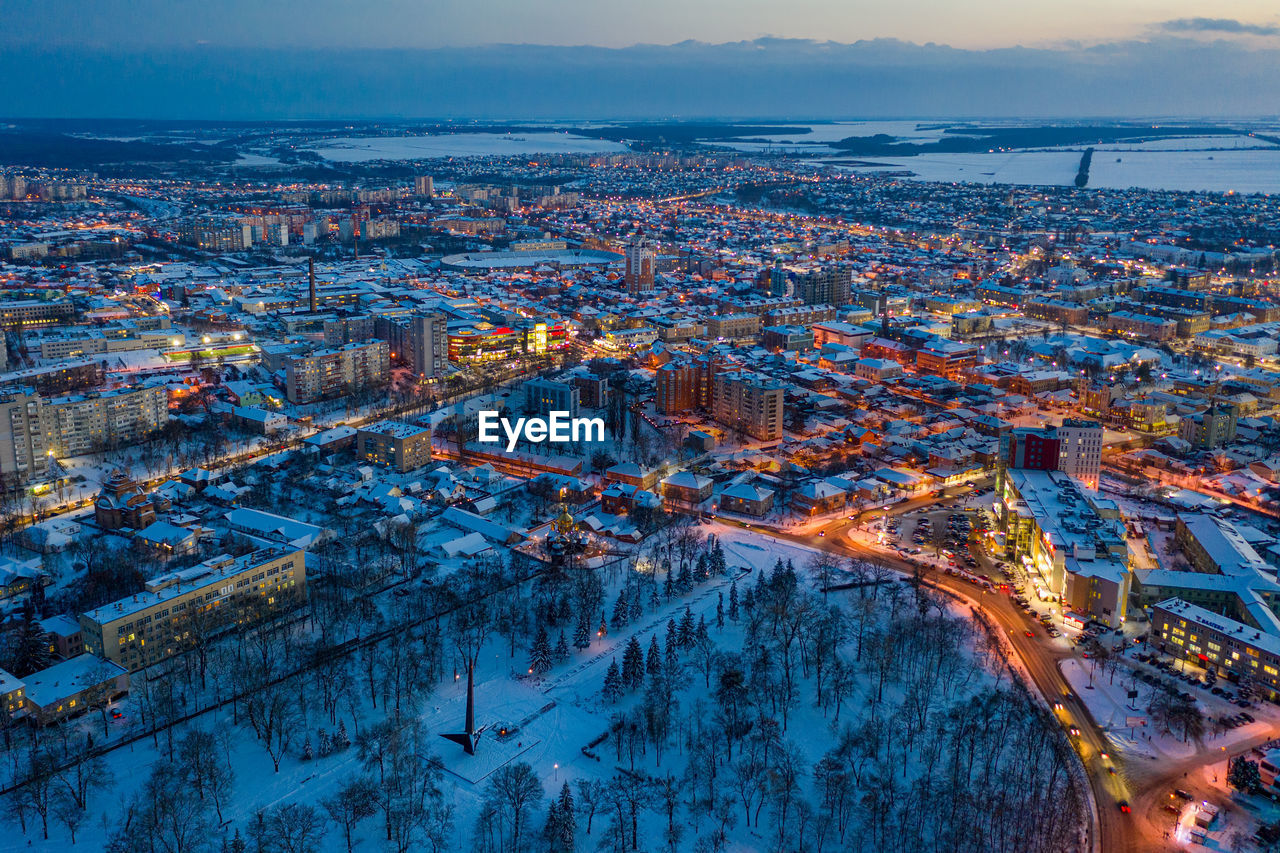 Beautiful evening top view of the city. winter city in the snow.