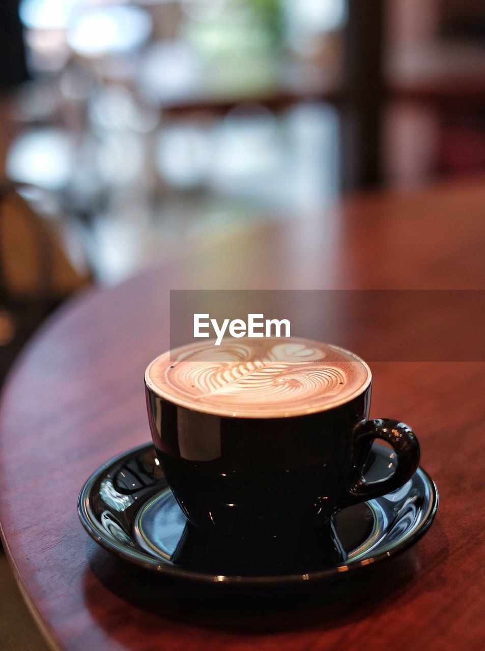 CLOSE-UP OF CUP OF COFFEE ON TABLE