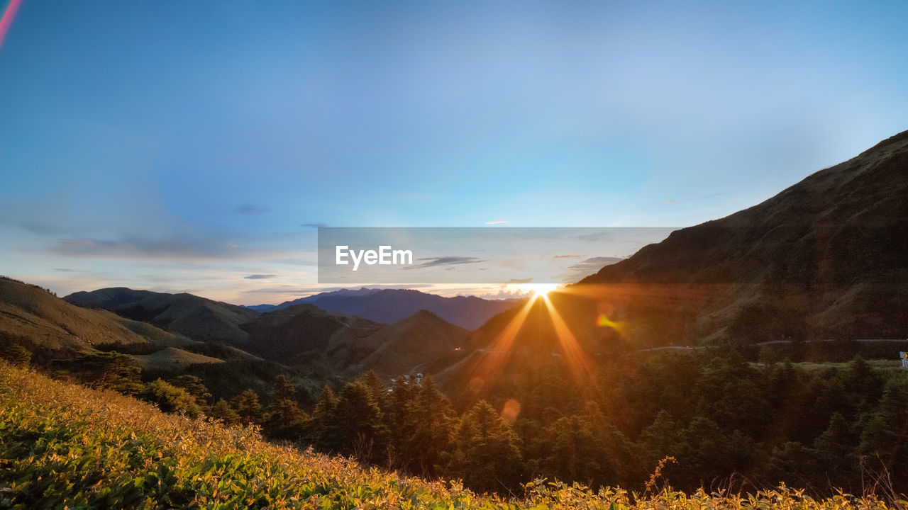 scenic view of landscape and mountains against sky