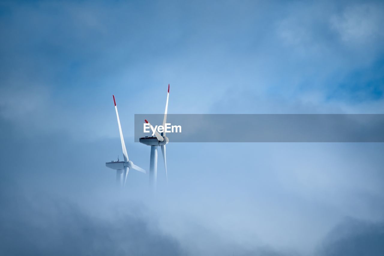 Low angle view of windmill against cloudy sky