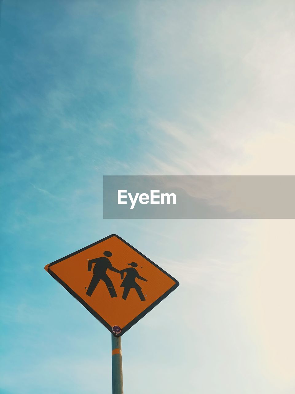 Low angle view of road sign against sky