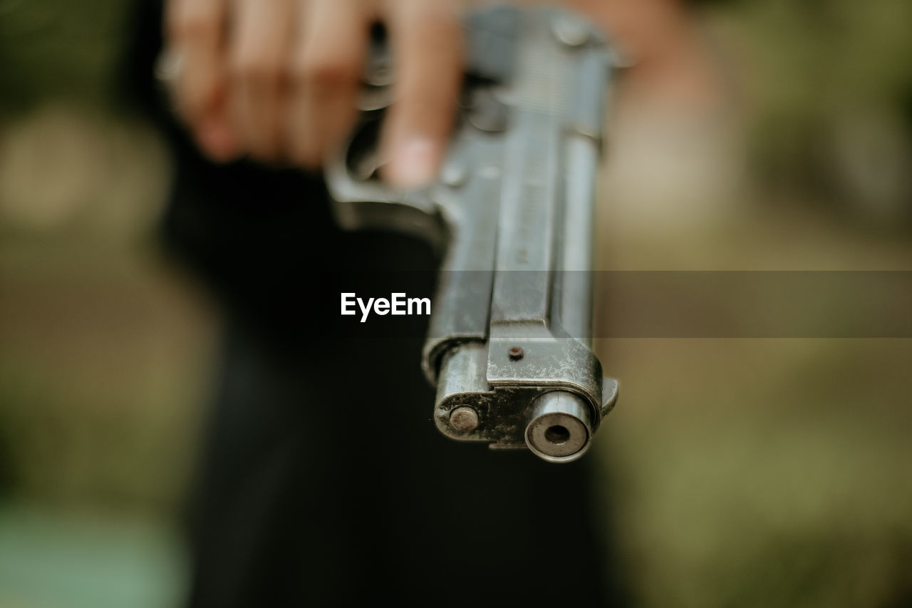 Close-up of person holding gun
