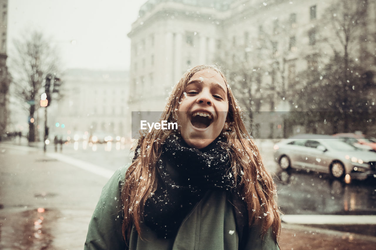 Portrait of smiling girl on street during winter