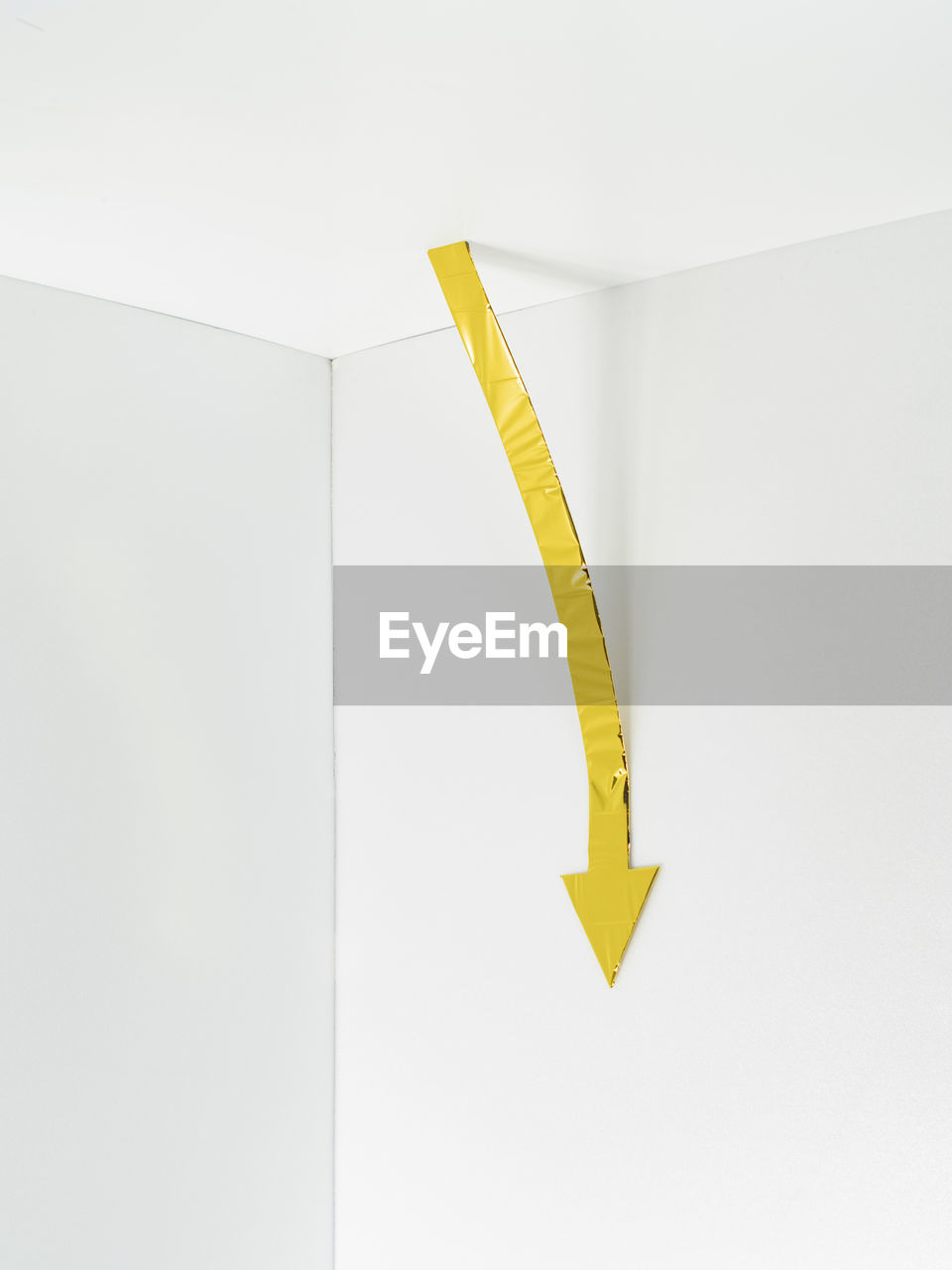 High angle view of yellow sign on white background