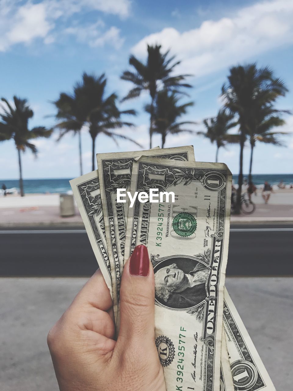 Cropped hand holding american currency