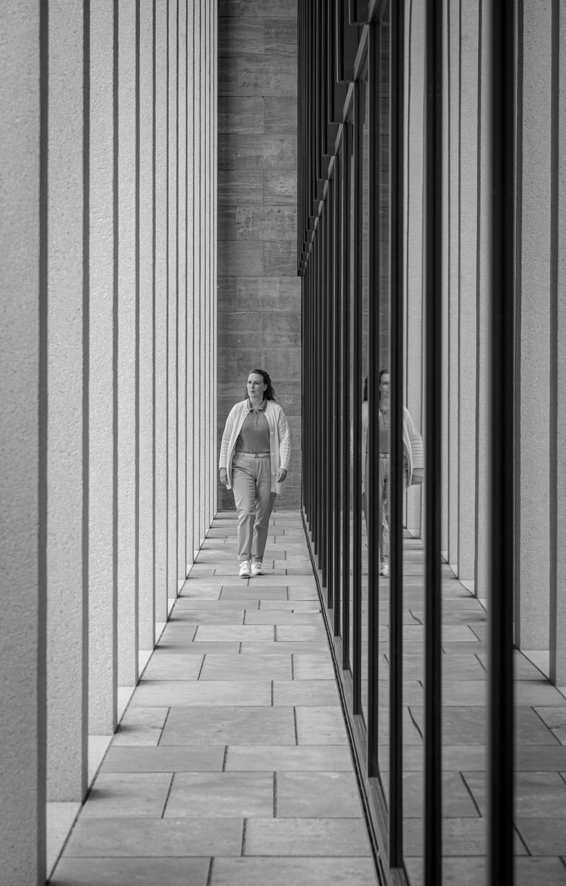 Full length of woman walking in corridor of building