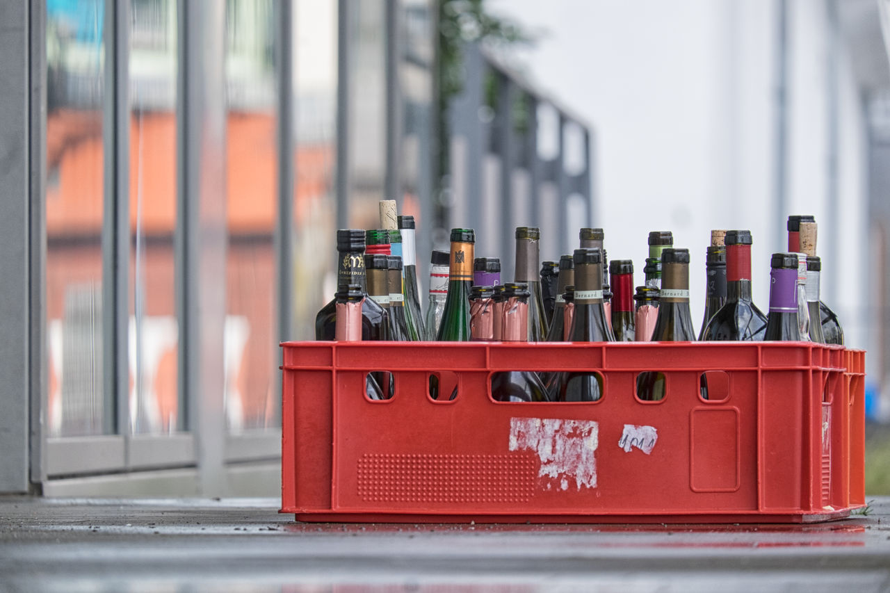 Close-up of empty bottles in red box