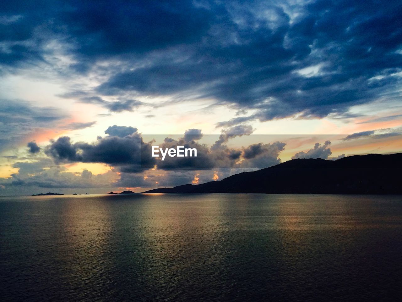 Scenic view of sea against dramatic sky