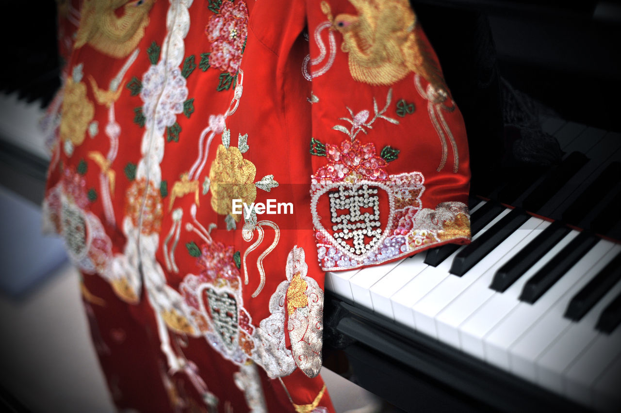 High angle view of chinese traditional dress on piano