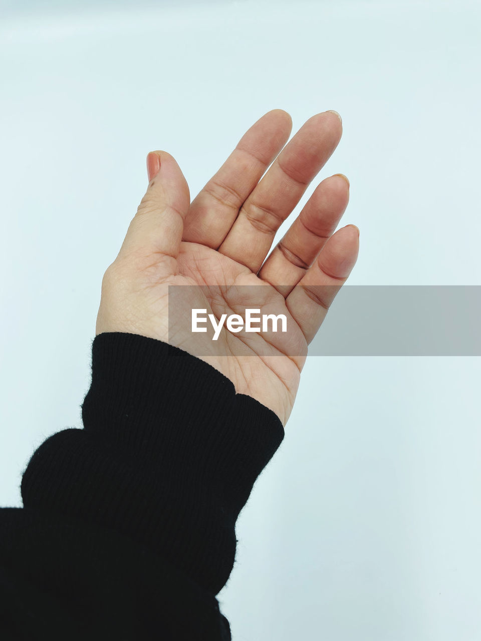 Cropped hand gesturing against white background