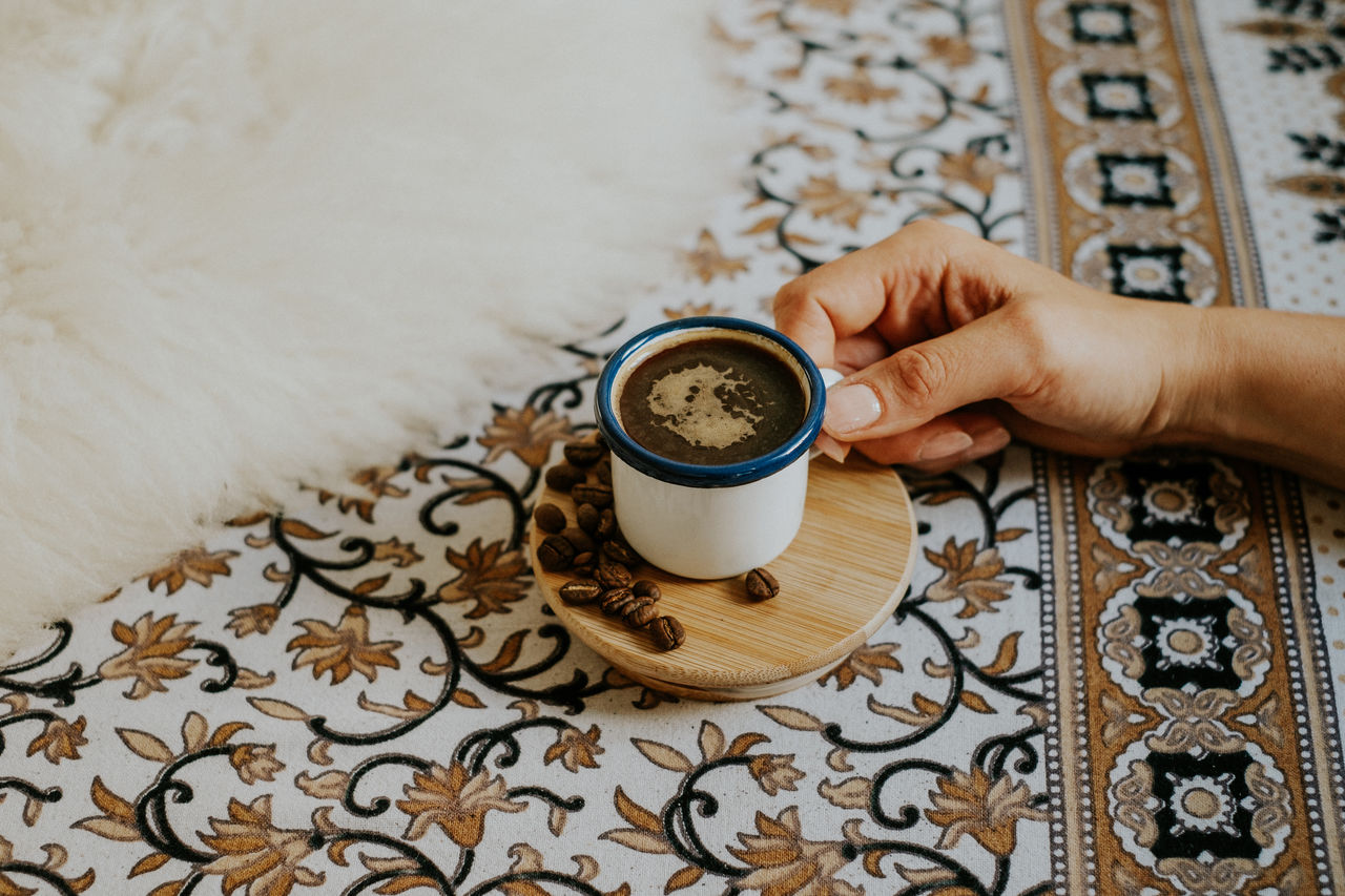 Cropped hand having coffee