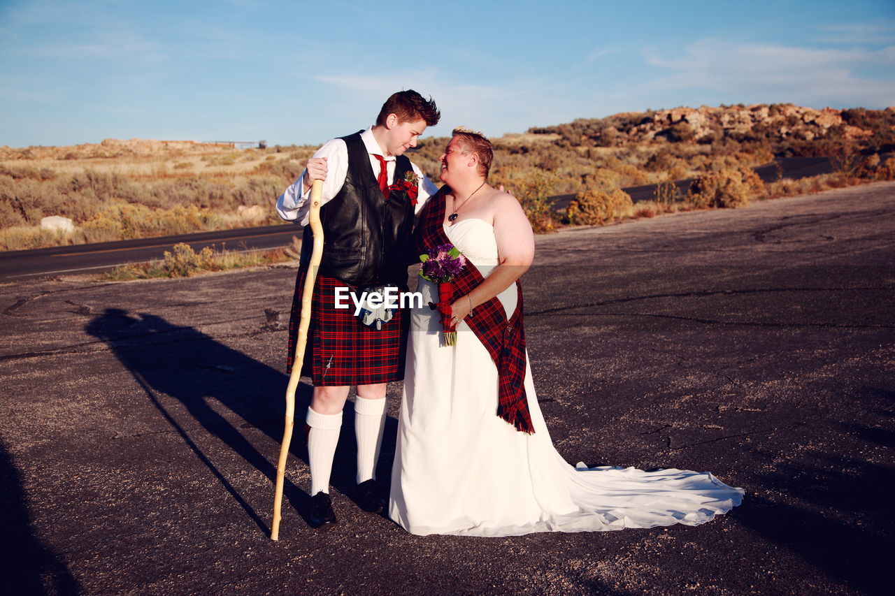 Full Length Of Lesbian Couple Smiling At Each Other On Eyeem