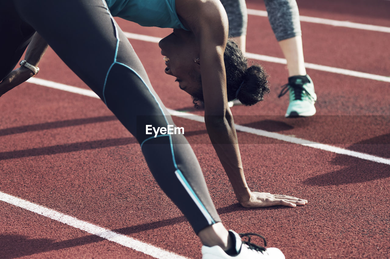 Athletes exercising on track