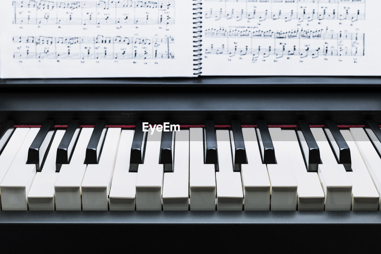 Black and white keys on a electronic piano pulsing an a chord